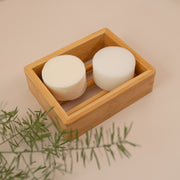 Photo of a shampoo and conditioner bar in a wooden dish tray