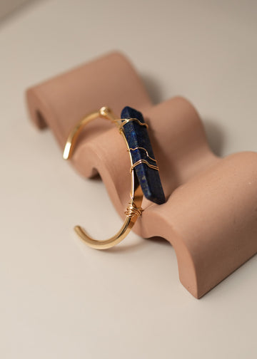 Cobalt Lapis Crystal Cuff Bracelet leaning on a stand