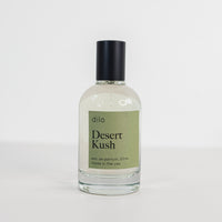 Perfume bottle on a white background with a green label saying "Desert Kush"