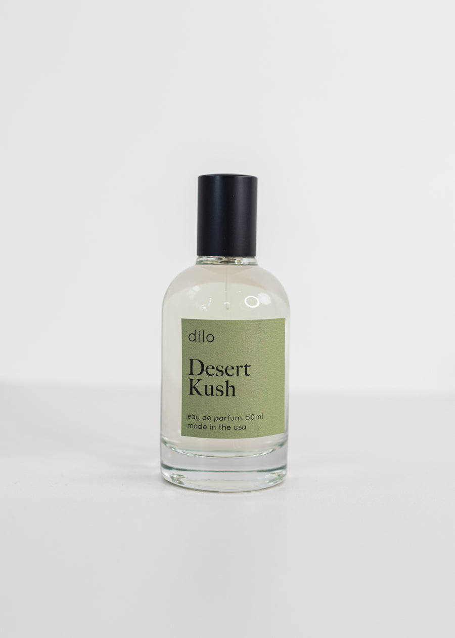 Perfume bottle on a white background with a green label saying "Desert Kush"