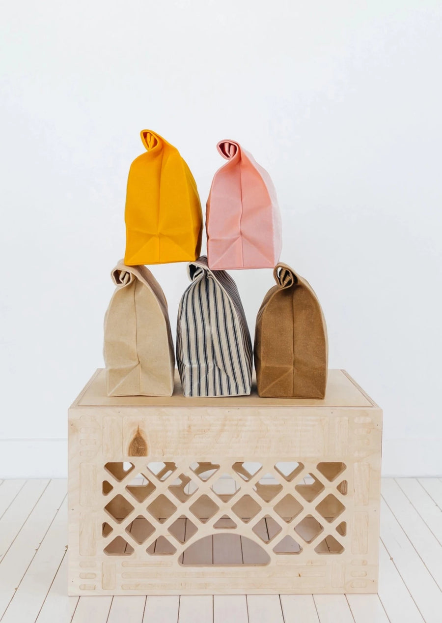Five Eco-Friendly Lunch Bags on a Wooden Crate