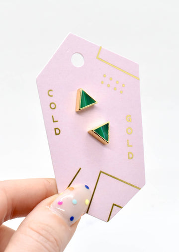Model Holding Jewelry Card with Emerald Triangle Gold Studs