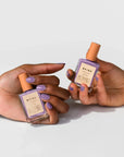 Two Hands Holding Vegan Nail Polish in Purple Hill by BKIND