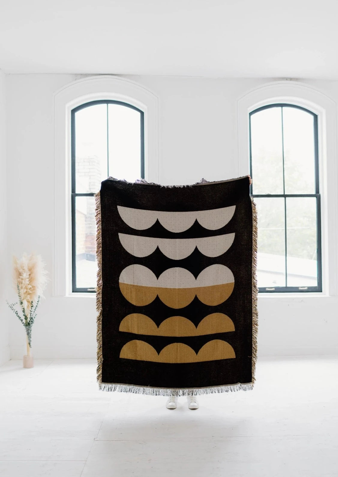 Woman holding up Moon Phases Cotton Throw Blanket
