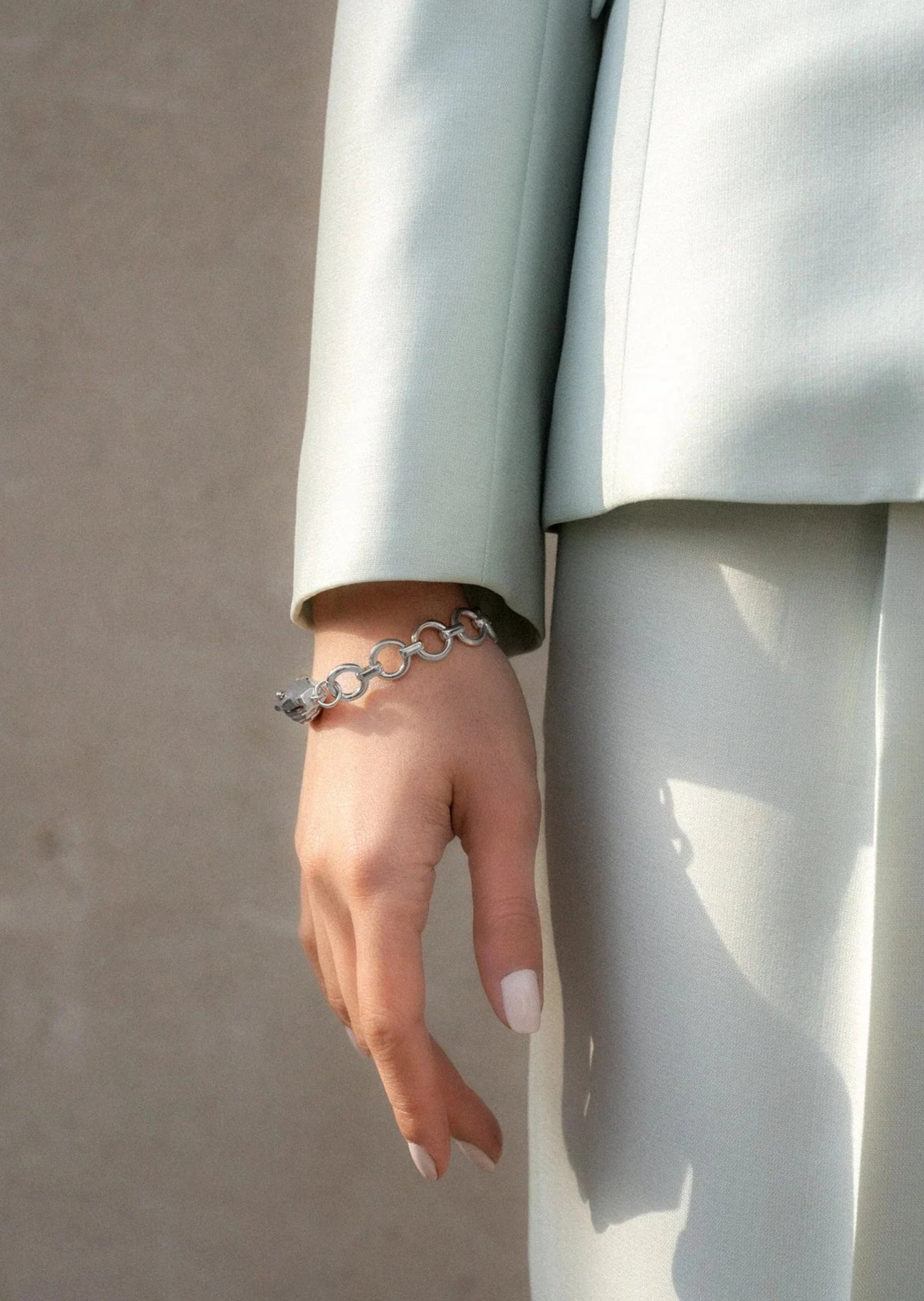 Models hand by her side wearing Gentlewoman&#39;s agreement bracelet