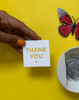 Woman holding a mini Thank You Card