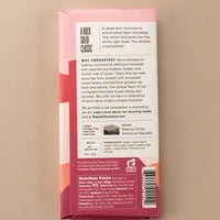 backside flatlay of the pink sea salt chocolate bar by Raaka with details on the ingredients, why they use unroasted chocolate, and nutrition facts