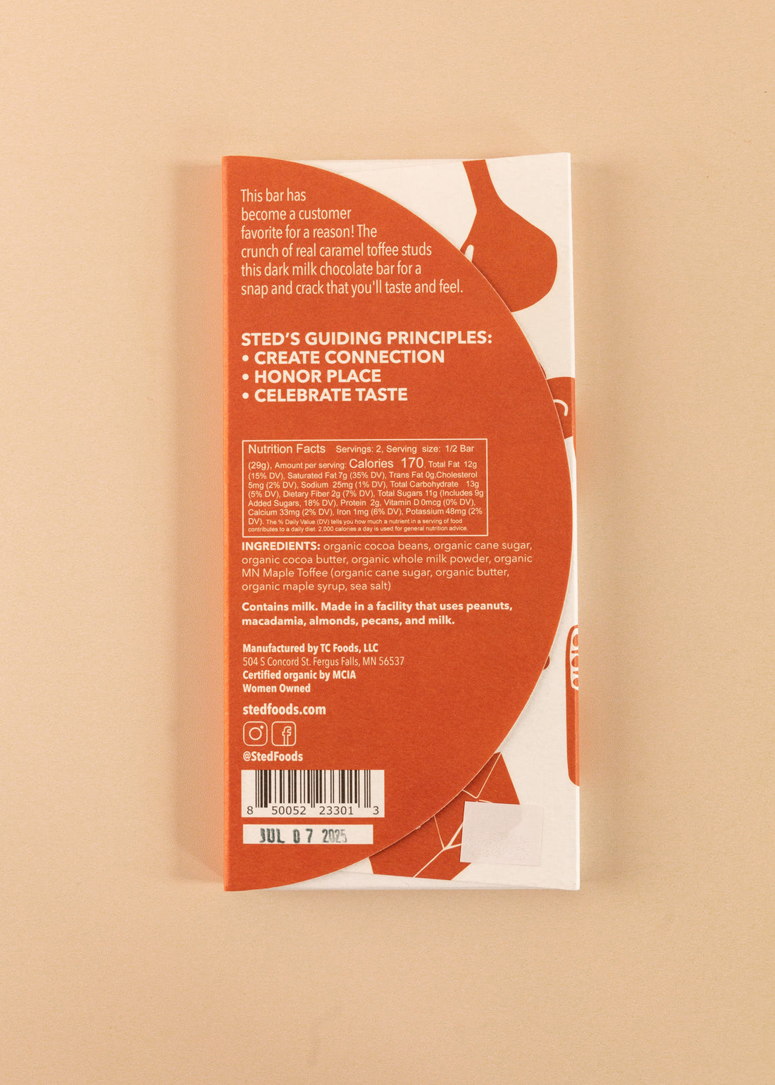 backside flatlay of the caramel crack sted 50% dark milk chocolate bar, with details on the ingredients and nutrition facts