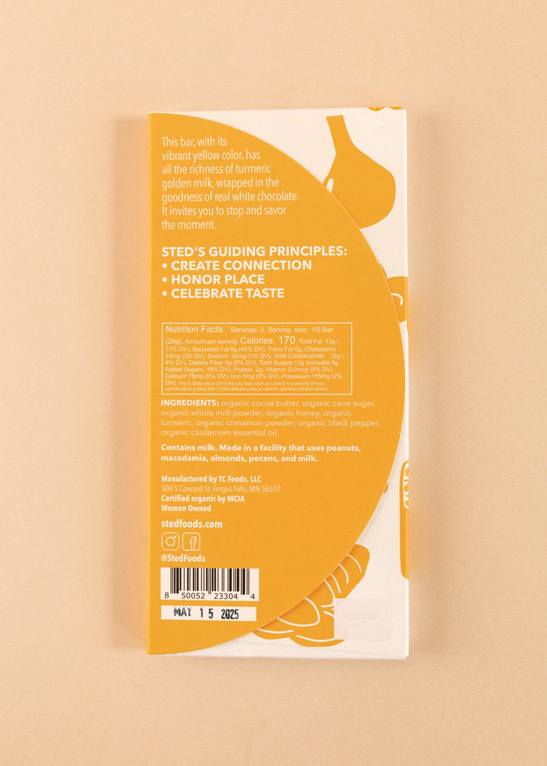 backside flatlay of the golden milk sted 38% white chocolate bar, with details on the ingredients and nutrition facts