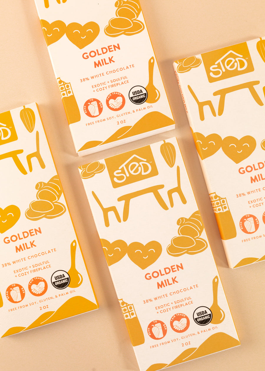 4 bars of the golden milk 38% white chocolate sted bars spread throughout the frame
