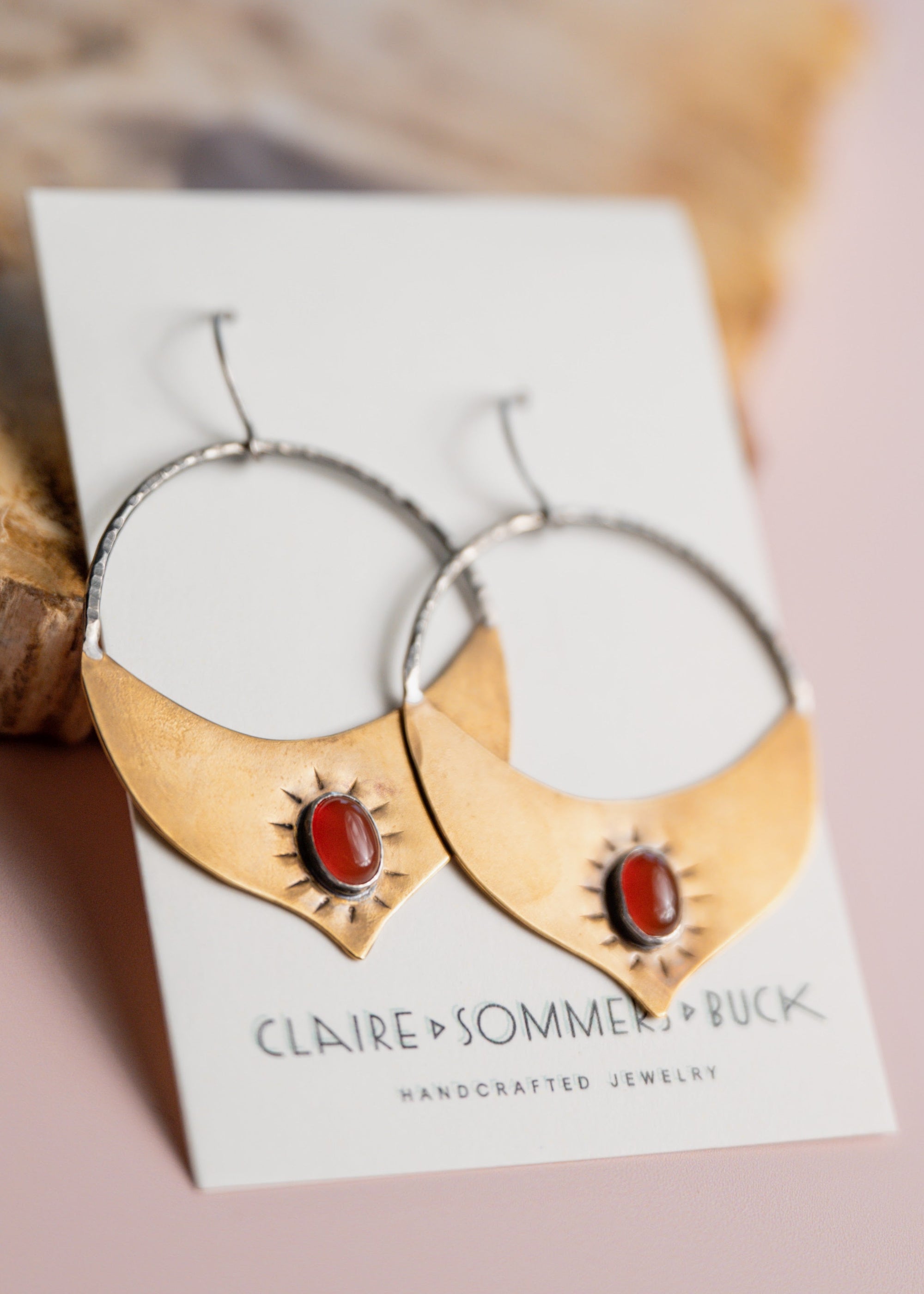 Gold Brass and Silver Madrasa hoop earrings with red stones by Claire Sommer Buck.