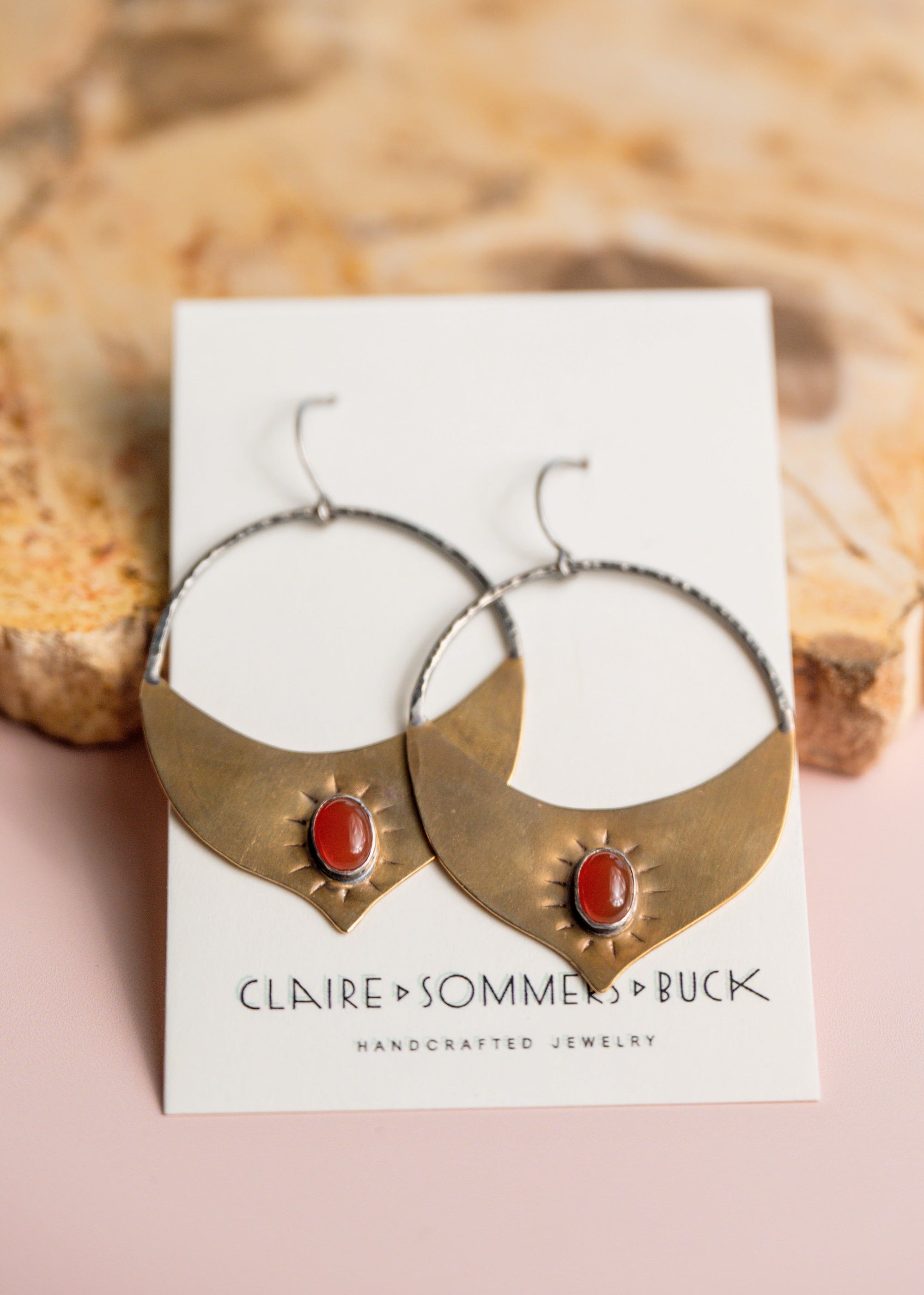 Gold Brass and Silver Madrasa hoop earrings with red stones by Claire Sommer Buck.