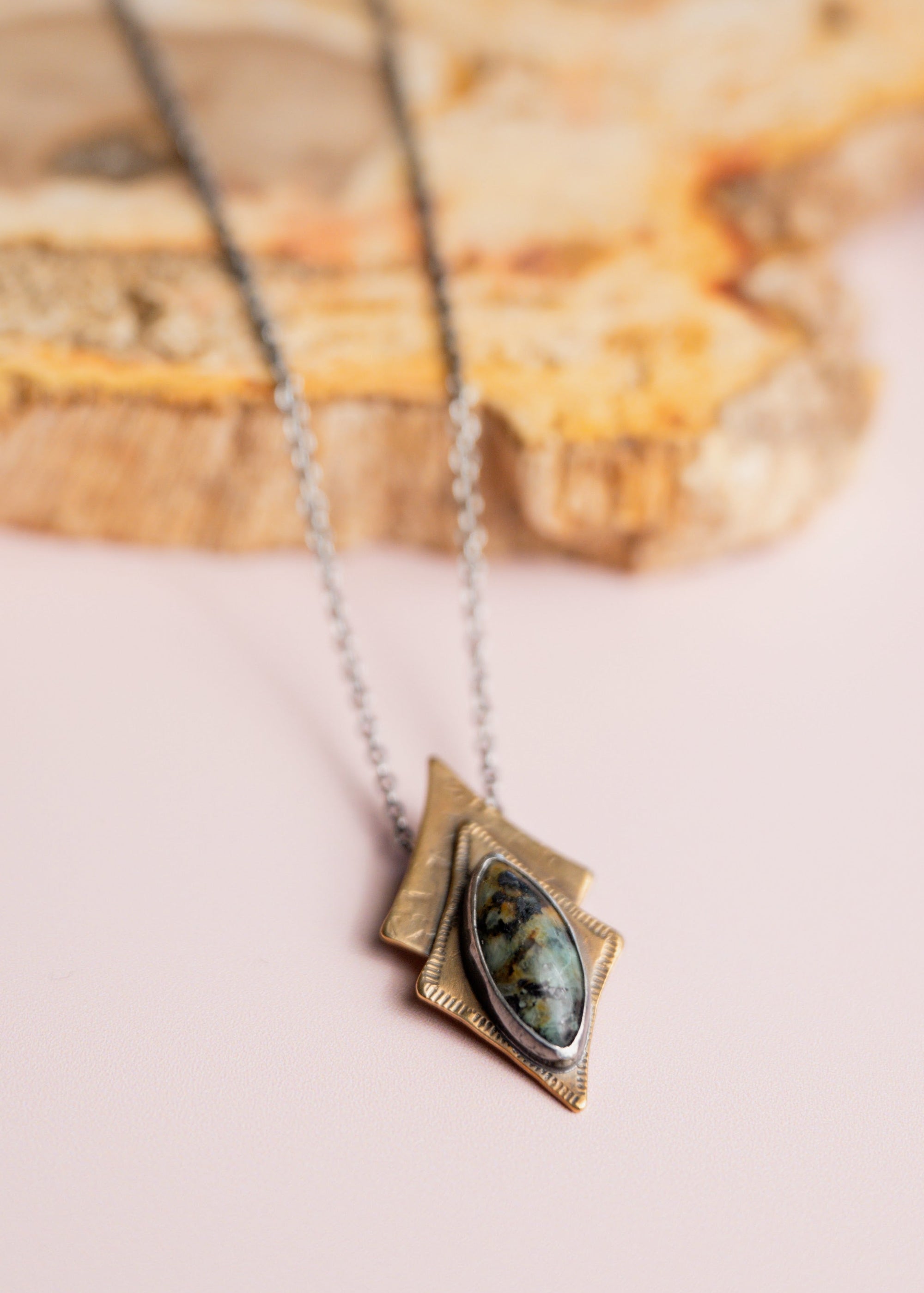 Necklace by 'Claire Sommers Buck' on soft pink background