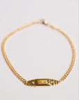 gold bar bracelet by gwen beloti on pink background