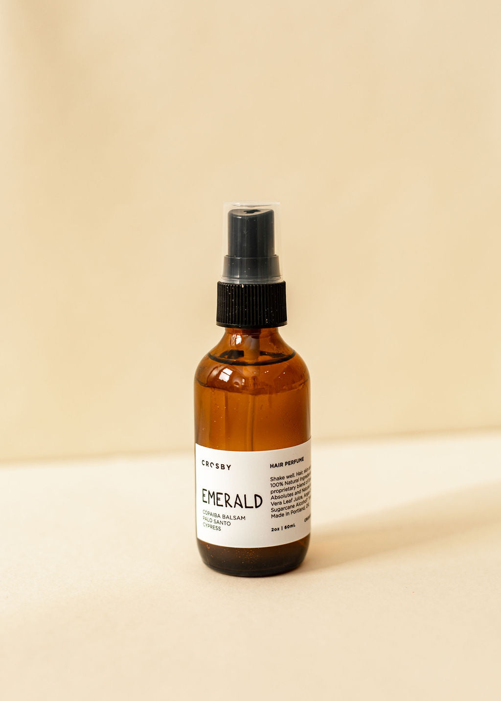 A single amber spray bottle of hair perfume, Emerald