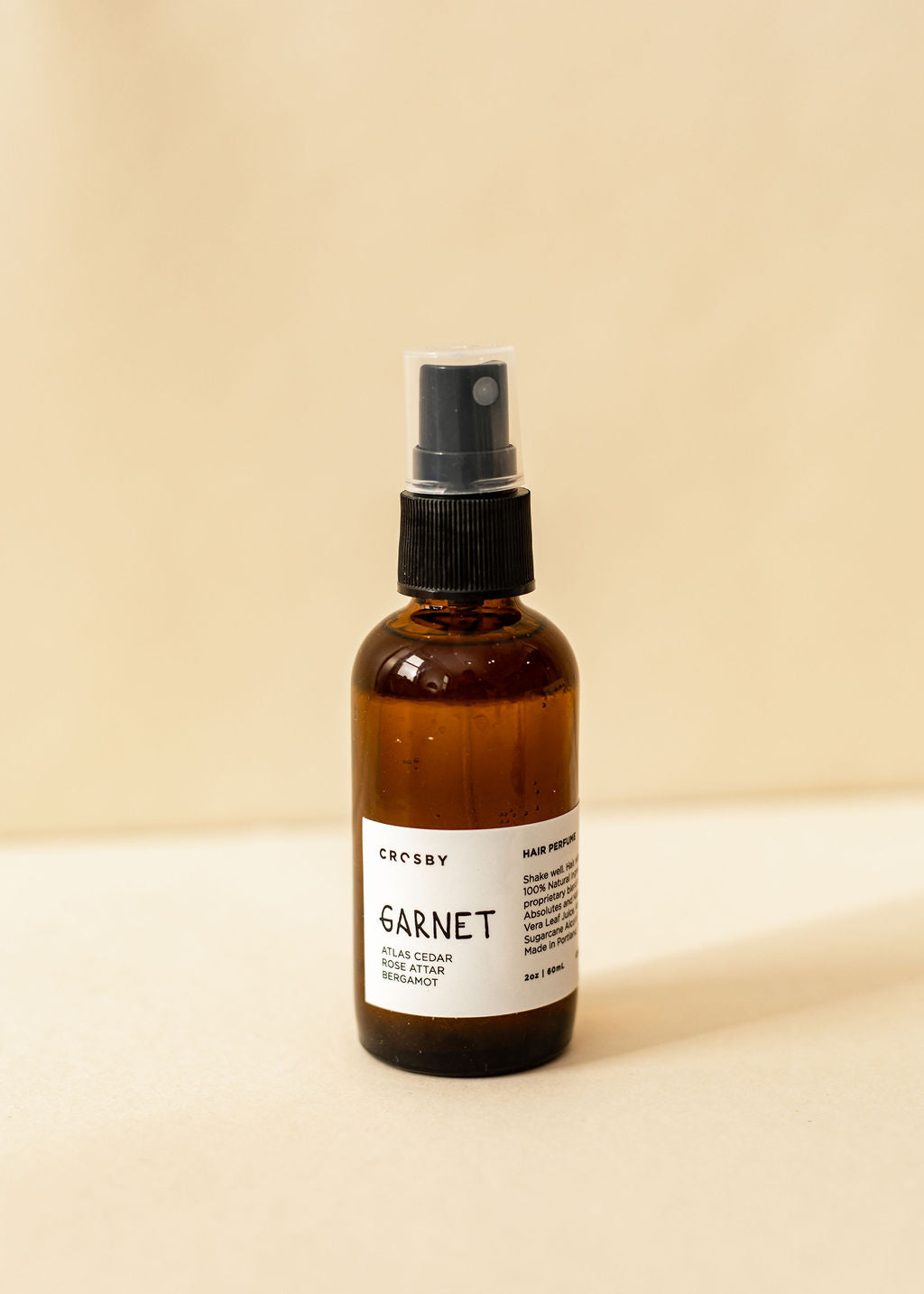 A single amber spray bottle of hair perfume, Garnet