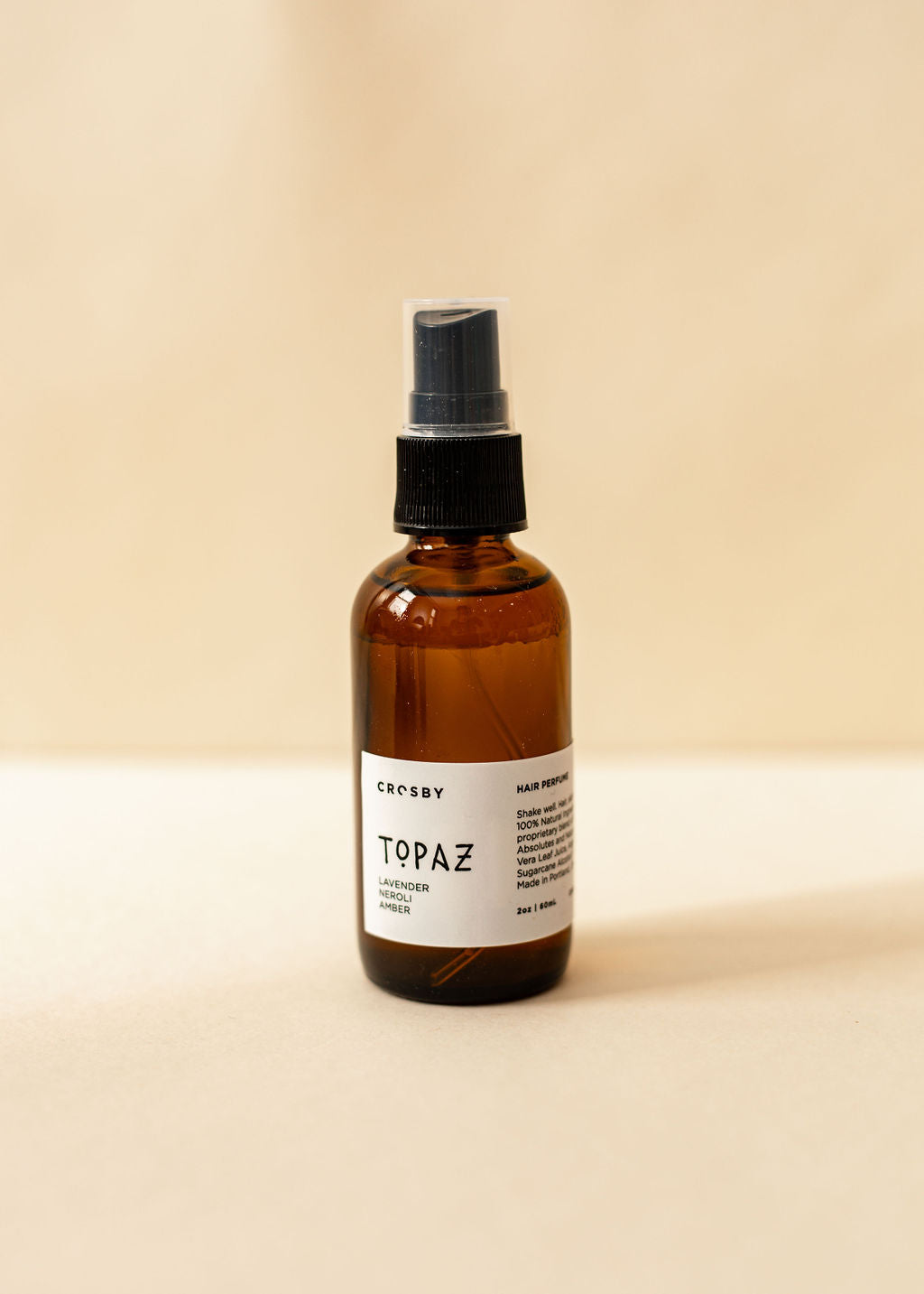 A single amber spray bottle of hair perfume, Topaz