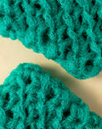 Close-up of two blue handmade dish scrubbies