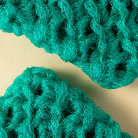 Close-up of two blue handmade dish scrubbies