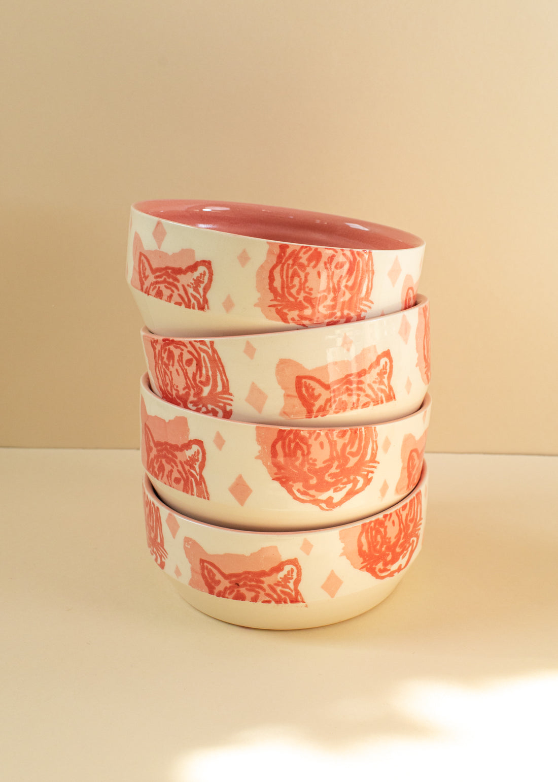 4 cream bowls with tiger faces screen-printed on them