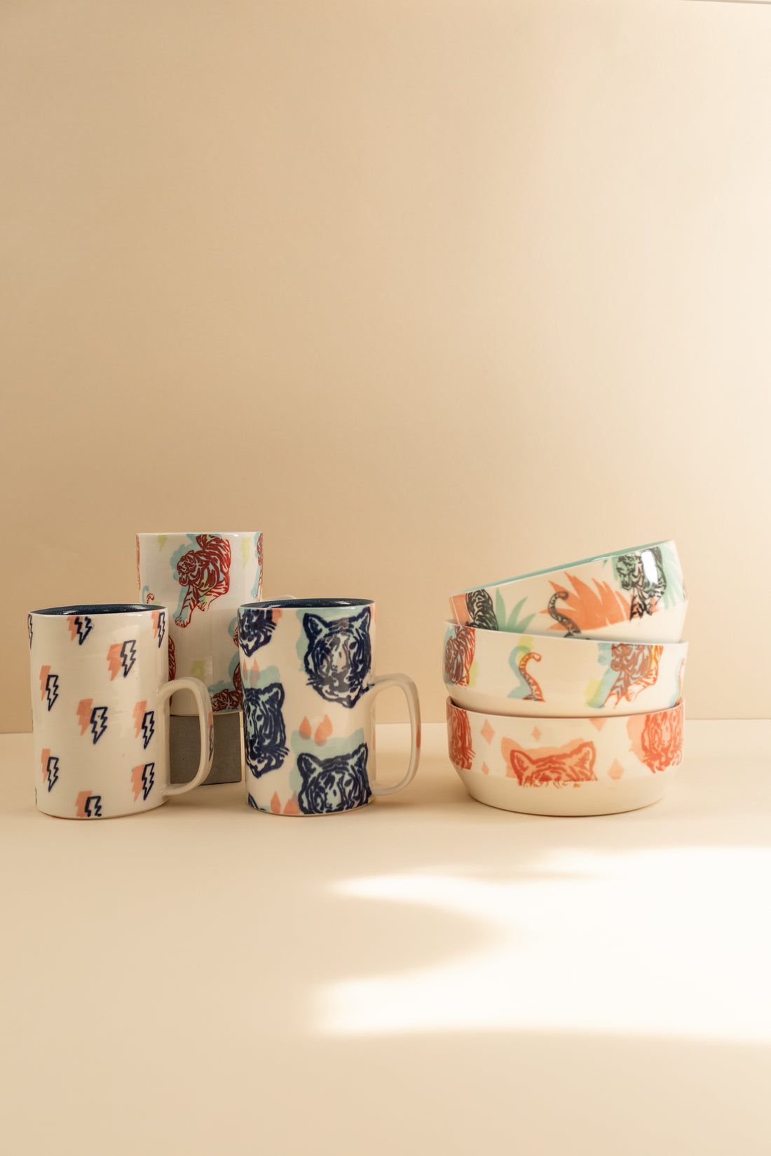 A variety of bowls and mugs with an assortment of tiger prints