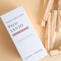 palo santo sticks on the right with the box in center